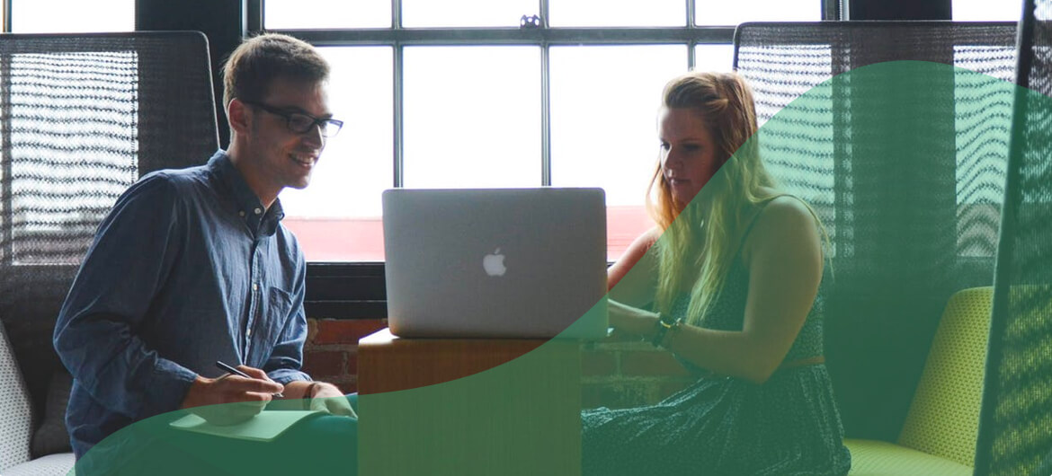 Image of two coworkers discussing ideas